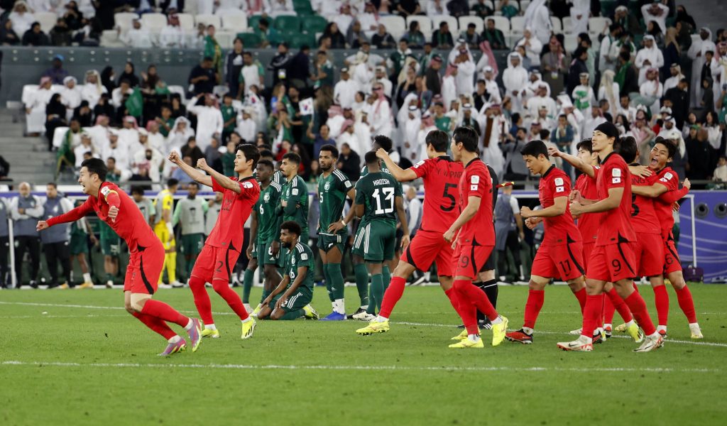 韩国在点球大战中胜出，球员们欣喜若狂；一旁的沙地阿拉伯球员则显得十分失落。——照片：路透社